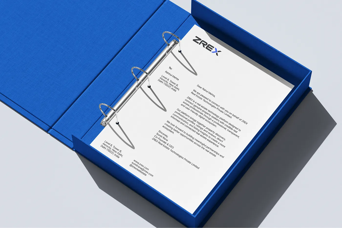 ZREX letterhead in a blue ring binder, real estate stationery design